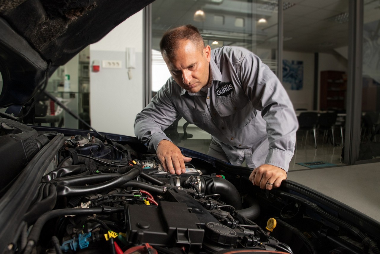 Mechanic and engine technician checking engine of a car
